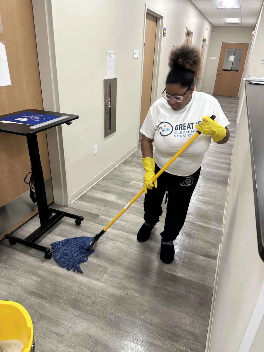 Great Job team member mopping a commercial corridor floor