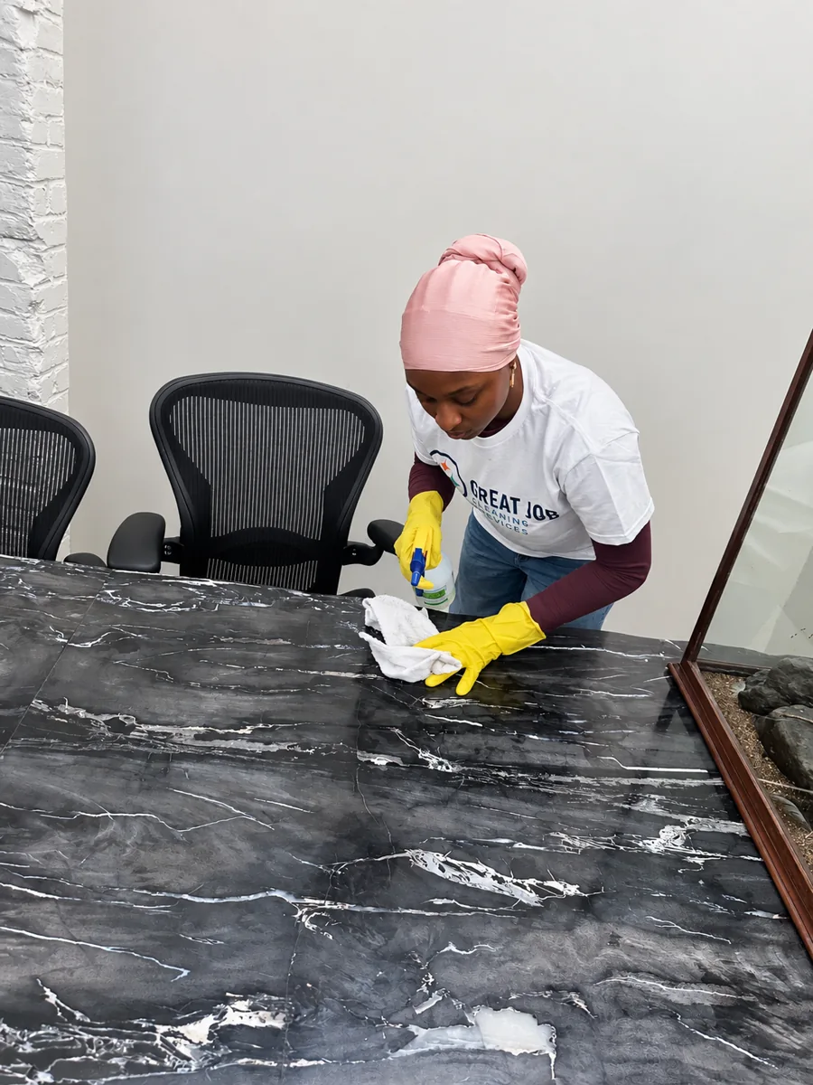 Great Job team member cleaning a commercial reception counter