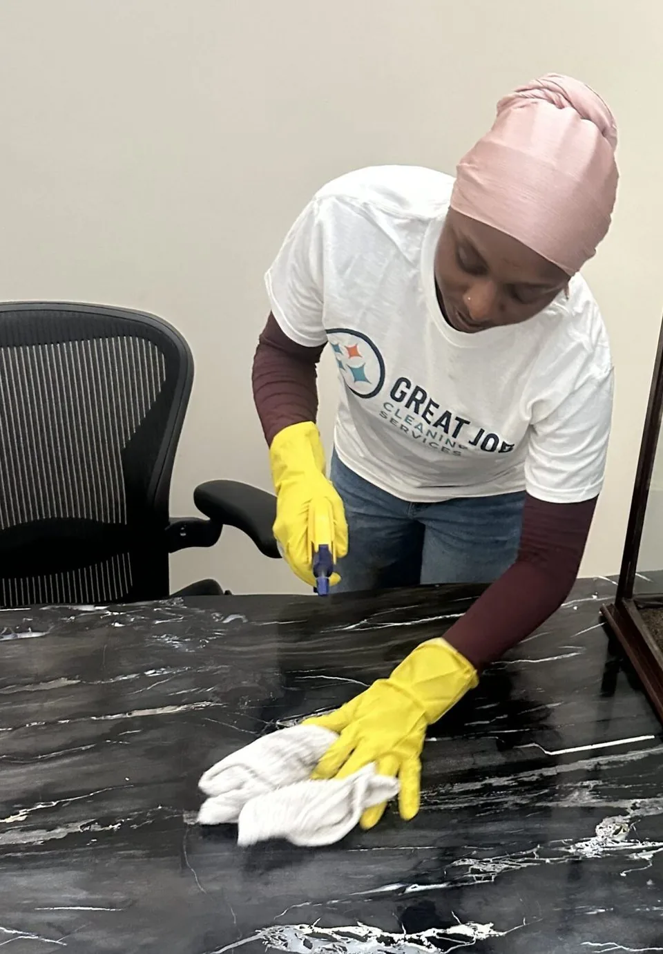 Great Job team member cleaning a front counter