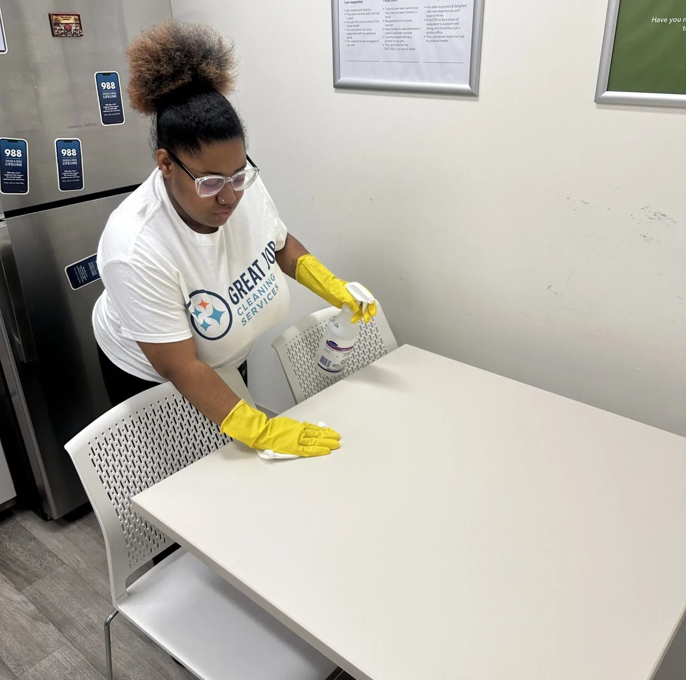 Great Job team member carefully cleaning a table